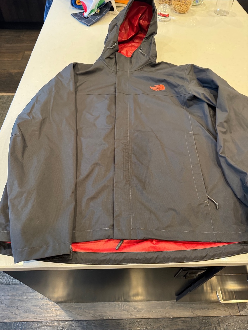The North Face Men’s Hooded Raincoat in Black with Red Lining